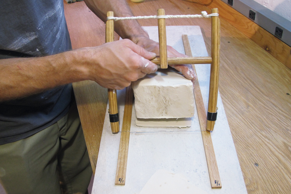 B Cutting a 1⁄8-inch slab of clay using the harp tool and slab sticks.