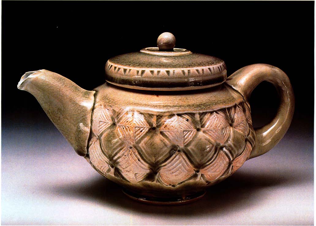  Salt-glazed teapot, approximately 6 inches (15 centimeters) in height, thrown, stamped and altered porcelain, with celadon glaze, fired to Cone 10 with wood and vegetable oil, by Sam Clarkson, Sewanee, Tennessee.