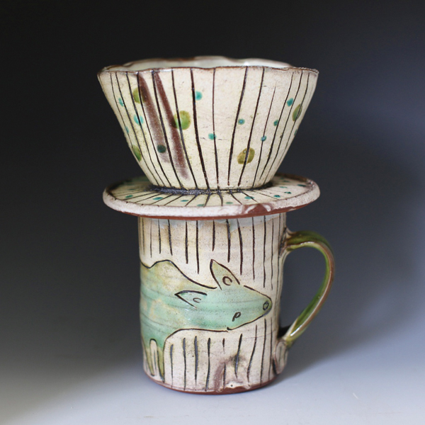 Maria Dondero’s Long Dog Mug and Striped Pour Over, 8 in. (20 cm) in height, 2017. All pieces by Dondero are earthenware, slip, glazes, fired to cone 1 in an electric kiln. 