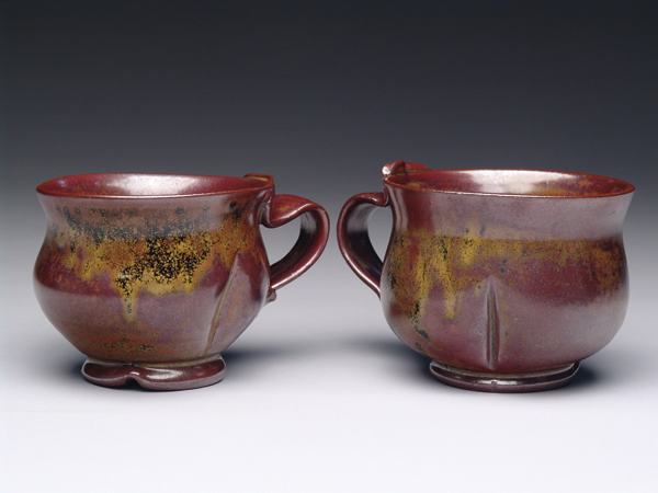 Mugs, 4 in. (10 cm) in height, stoneware with Temmoku Gold, gas fired in reduction to cone 6, by Luba Sharapan.
