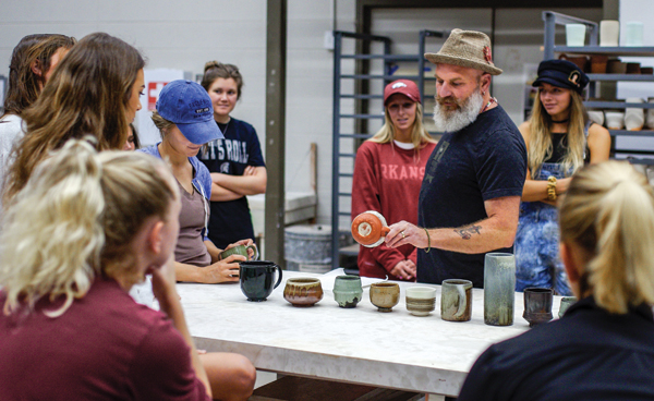 Photo: Mathew McConnell and Intro to Wheel Throwing students at the University of Arkansas.