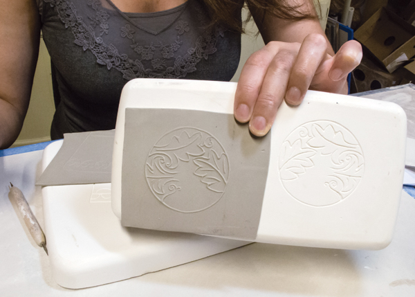 3 The carved design is now transferred onto your thin clay slab. This slab will become the bottom of the cup.