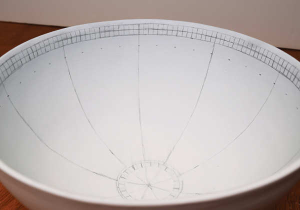 4 Pencil in lines following the curve of the bowl. Continue dividing the bowl into sections.