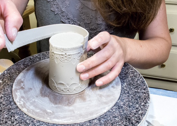7 Once the bottom of the cup is in place, add a raised foot by scoring and slipping a thin strip around the base.