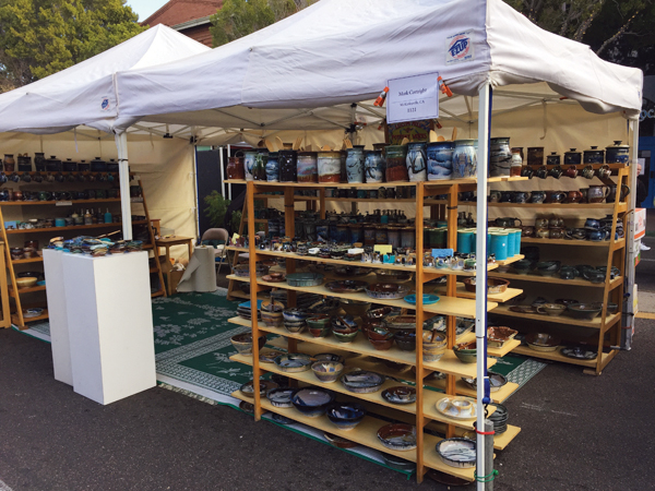 View of Mark Cortright’s double-booth setup for his business Liscom Hill Pottery during Tempe, Arizona’s Festival of the Arts in December 2016. This was his last show after 24 years at this venue.