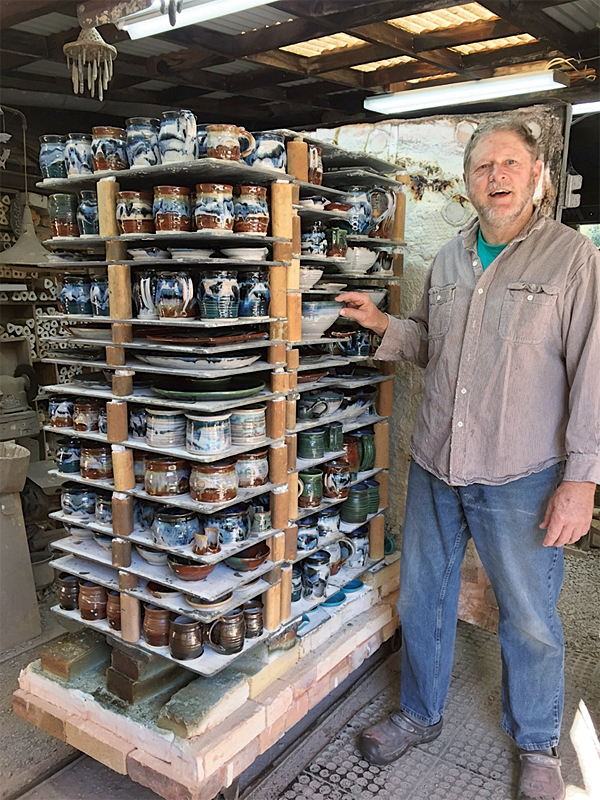 Mark Cortright with his homemade, 35-cubic-foot car kiln with Advancer kiln shelves. The work in the kiln is all porcelain, and was fired to soft cone 11 in a reduction atmosphere. Photo: Linda Miller.