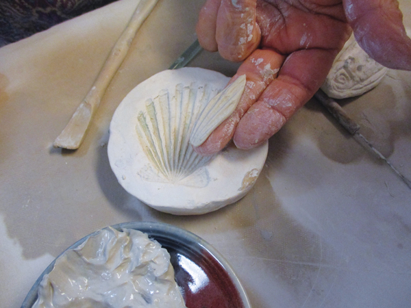 6 Using a plaster mold of a shell, press out four pieces to mimic dragonfly wings.