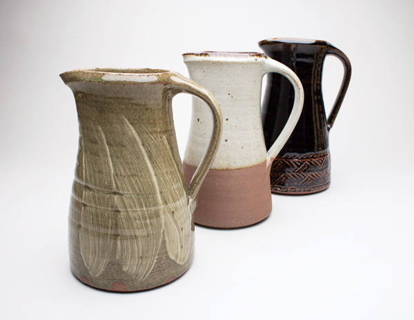 1 Standard Ware pitchers created at Leach Pottery, stoneware, ash, dolomite, and tenmoku glazes, fired to 2336°F (1280°C). Photo: Sarah White.