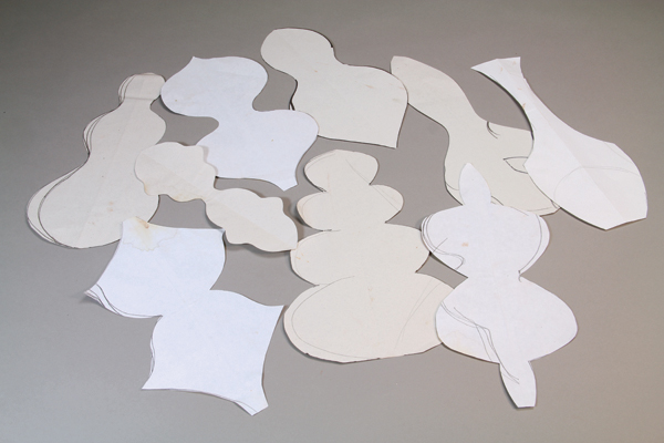 1 Draw silhouettes of symmetrical shapes, then make paper templates by folding the paper in half and cutting out the shapes. These must be symmetrical to work for the quarter-segment mold process.
