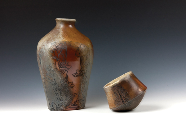 1 Denise Joyal’s Floral Whiskey Bottle and Rolling Whiskey Cup, to 9 in. (23 cm) in height, wheel-thrown and altered white stoneware, flashing slip, mishima design, liner glaze, wood and soda fired. 