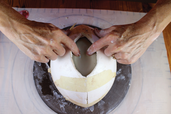 9 Gently press the clay down into the center bottom of the oval hole to create a dimpled bottom.