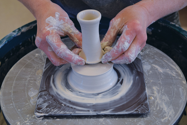 3 Use a wood trimming tool to cut a groove at the base of the handle and remove with your fingertips.