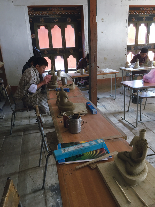 8 Second-year student at the Zorig Chusum, Bhutan’s only higher education arts institute, making a traditional Bhutanese Buddhist statue, called a Kusa.