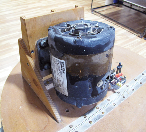 1 The motor is mounted to a mount that was made out of 3⁄8-inch plywood. The motor is bolted to a square piece of wood.