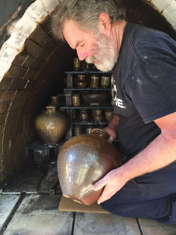 4 Pickett unloading a jar from his anagama kiln.