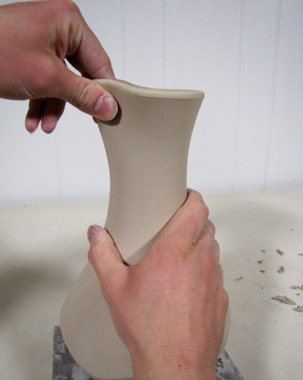 6 Form the rim into a spout by pulling with wet fingers to create the throat.