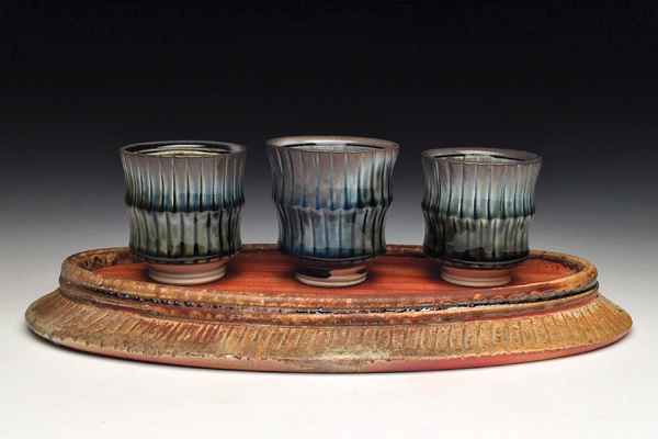 2 Whiskey flight and stand, 15 in. (38 cm) in length, wheel-thrown porcelain cups, soda fired to cone 11, wheel-thrown stoneware stand, wood fired to cone 10, wood insert, 2018. 