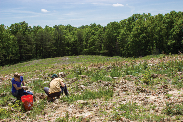 1 Kylie Schmidt and Leah Combs collecting clay materials from previously strip-mined land as it is being rehabilitated for new trees by Green Forests Work.