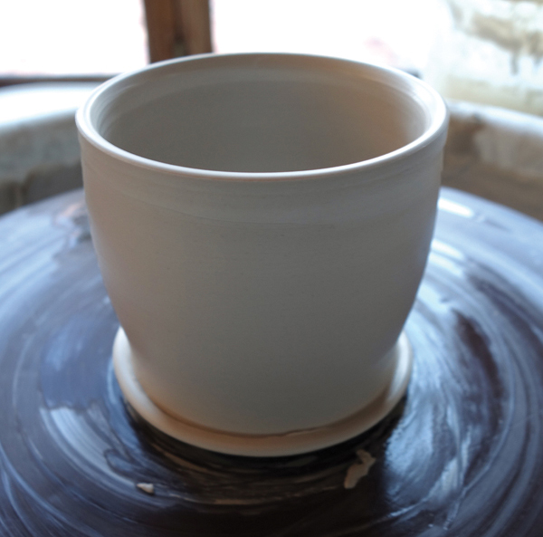 6 Throw a cup that fits within the carved space on the base.