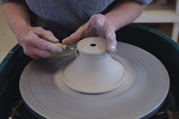 7 Trim some clay from the top of the lid to begin shaping the knob.