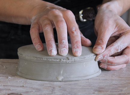 6 Score the attachment areas on the curved slab and walls of the lid, apply slip, then attach the pieces.