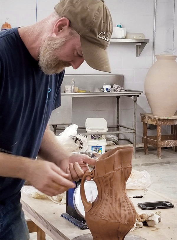 9 Botbyl puts the finishing touches on a pitcher handle during the Handle with Care workshop presented with Matt Schiemann and Todd Pletcher at STARworks in Star, North Carolina, 2017. Photo: Tameria Martinez.