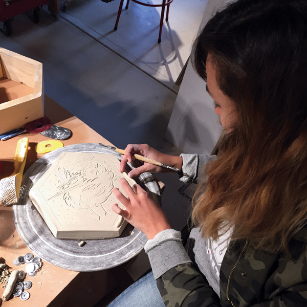 1 Eliane Medina, a Rat City Studios assistant, carving a paver model.