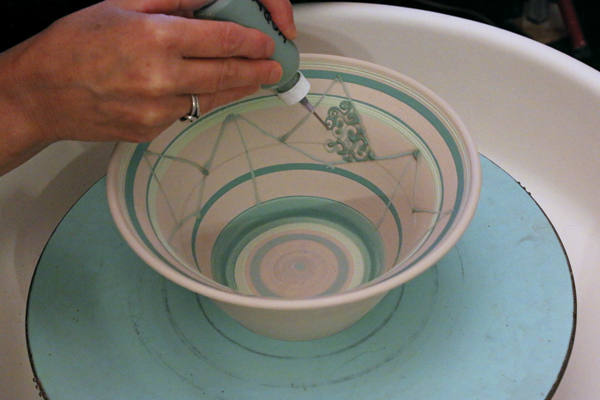 3 Apply underglaze water symbols within the upper triangle shapes.