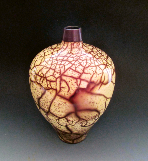 Splendid, 12 in. (30 cm) in height, Hilite red mica-infused terra sigillata, naked raku fired.