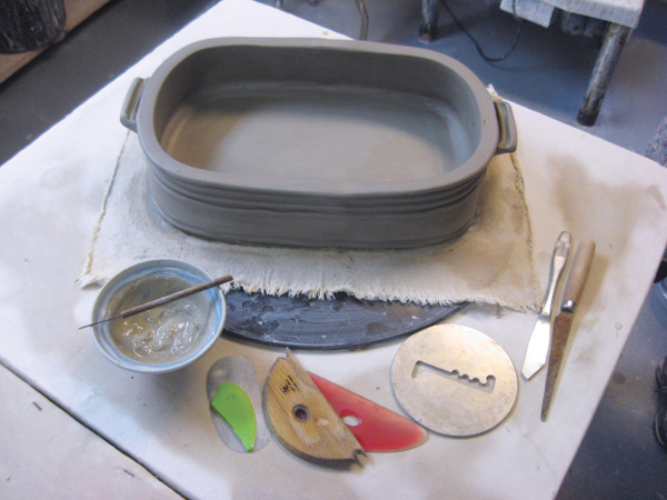 12 The completed baking dish. The dish should be assembled on a piece of canvas or newsprint, or placed on one for drying so that the bottom can shrink and move without causing cracking. Once the dish is complete, cover it with plastic and let it dry slowly for several days before bisque firing.