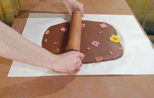 1 Rolling craft-foam cutouts into a 3⁄8 -inch thick slab.