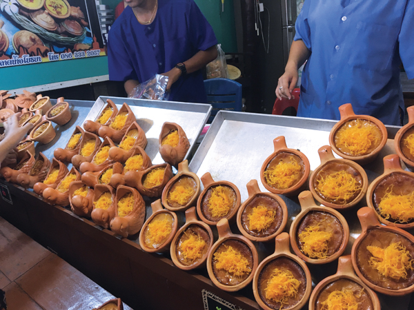 4 The flan-like desserts at the Tung Bua Chom Floating market baked into the terra-cotta pieces and sold as is.