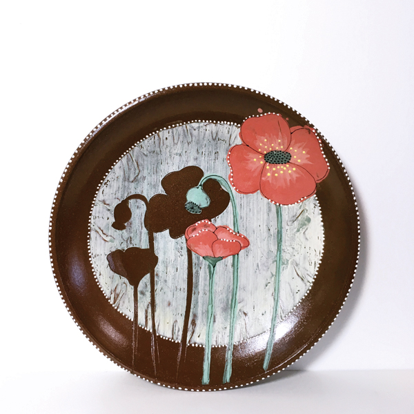 6 Teresa Pietsch’s poppy platter, red clay, colored slip transfer, fired to cone 1 in a gas-fired soda kiln.