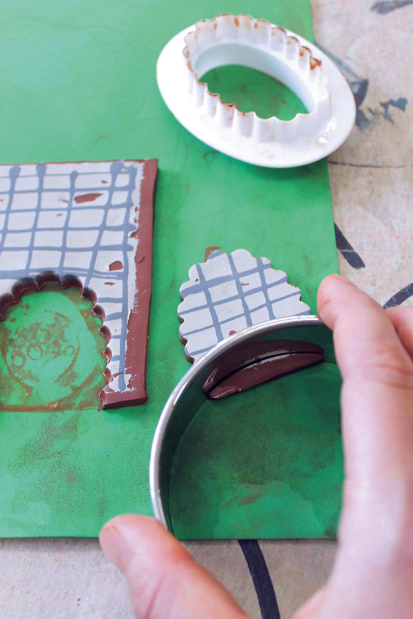 10 Use cookie cutters to cut the interior of the half-oval into a curve to match the curve of the mug wall.