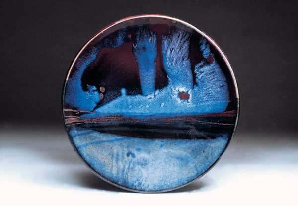 6 Les Miley, Astral Horizon, 20 in. (51 cm) in diameter, porcelain, glazed with copper red and basic black, chun-type glazes, with copper and rutile poured over base glazes, fired to cone 9 in reduction.