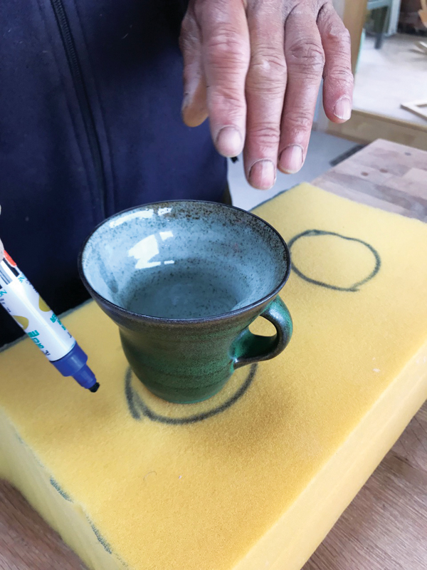 4 Outlining the shape of the mugs that need to be shipped onto the foam.