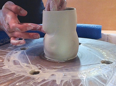 2 With the basic shape formed, press from the inside of the cup to form the breasts.