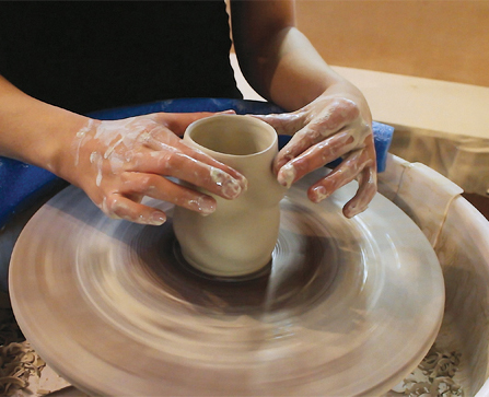 4 After altering the form, collar the rim of the cup to narrow and recenter it.