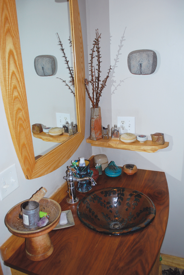 3 Collaboration of Doug Sigler’s wood vanity and Kent McLaughlin’s sink. On the vanity from left to right: David Stuempfle’s pedestal bowl; Mary Barringer’s plate as soap dish; George Bowes’ double-handled cup; covered jars by Warren MacKenzie, Kent McLaughlin, Silvie Granatelli and Michael Simon; Gay Smith’s tiny vase. On the shelf from left to right: Jan McKeachie Johnston’s tall vase, Andrea Sorenson’s sculpture, Silvie Granatelli’s covered jar, Susan Filley’s covered jar, Beth Lambert’s neti pot. On the wall: Mary Barringer’s sculpture. 