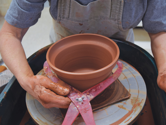 2 Measure the diameter of the pot right below the ledge using calipers. This will be the diameter of the rim of the outer pot.