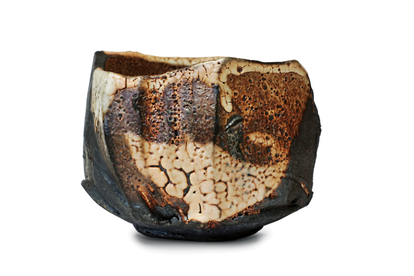 1 Elena Renker’s faceted teabowl, 5 in. (12.5 cm) in length, black stoneware clay, shino glaze, fired to cone 10 in a wood kiln.