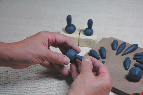 9 Score and slip the indentation in the topper ball and insert the knob or flourish.