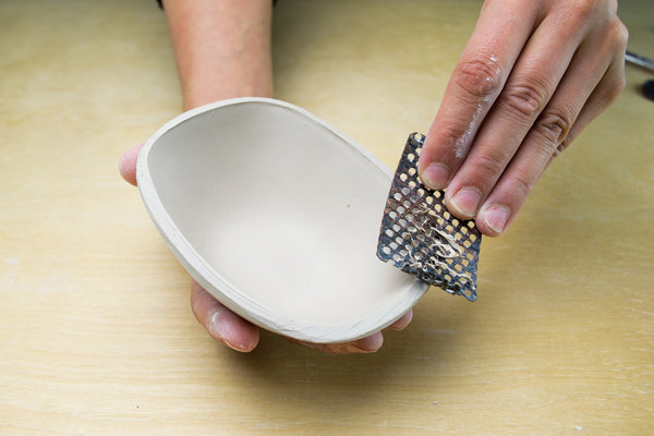 6 Use a Surform to level and refine the rim of the milk bowl.