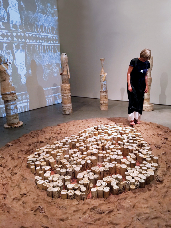 6 Patricia Sannit walking through the clay at her exhibition, Time Stands Still, at Gerbert Contemporary Gallery, February 2016. 