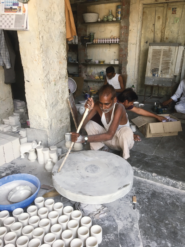 2 A worker hand cranks the wheel before throwing.