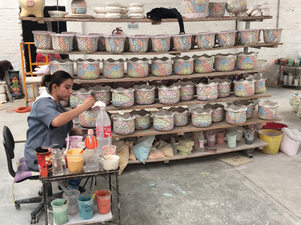 7 Worker decorating pottery at the Castillo Talavera factory in Dolores Hidalgo, Mexico.