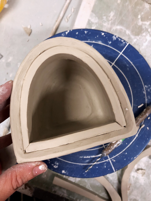 7 Fit strips of clay into the rim of the canister, shaping them for use in the flange.