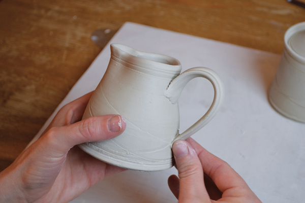 7 Cut and attach the leather-hard, doubled handle to the creamer