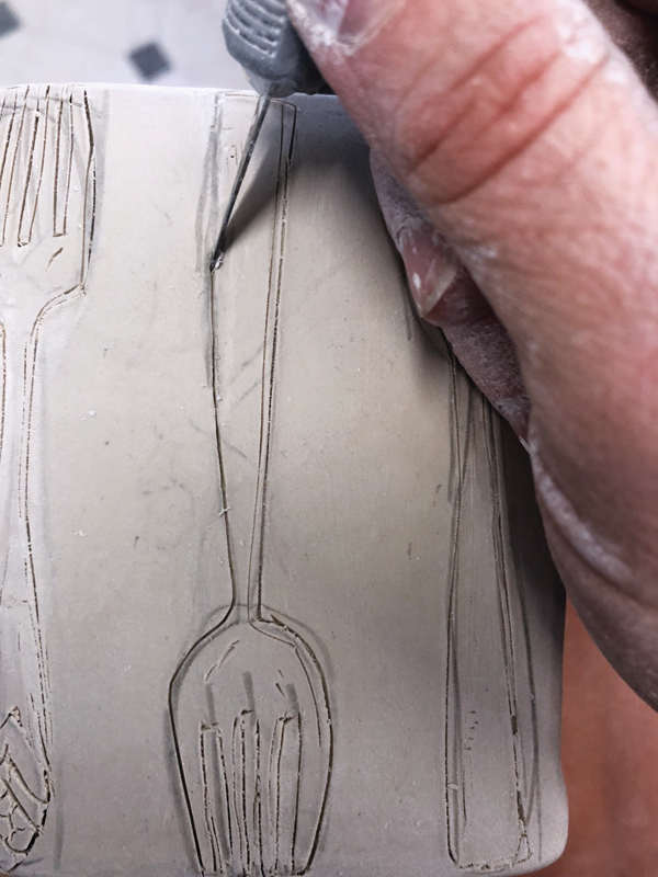 14 Draw imagery with a pencil on the set, then carve with X-Acto blade.