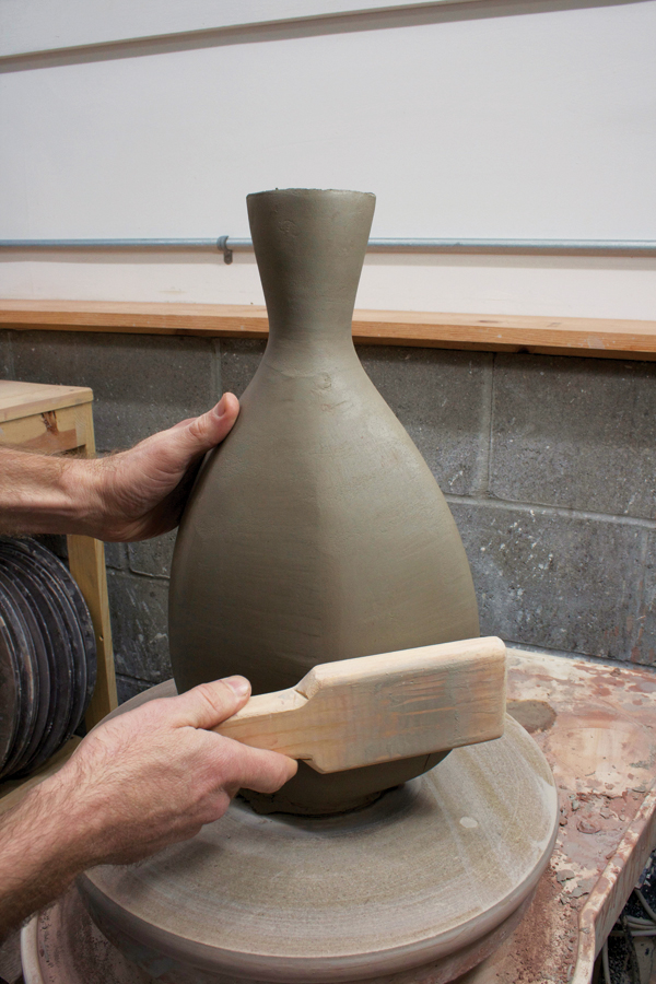 6 Paddle the cylinder, moving the clay with multiple passes.